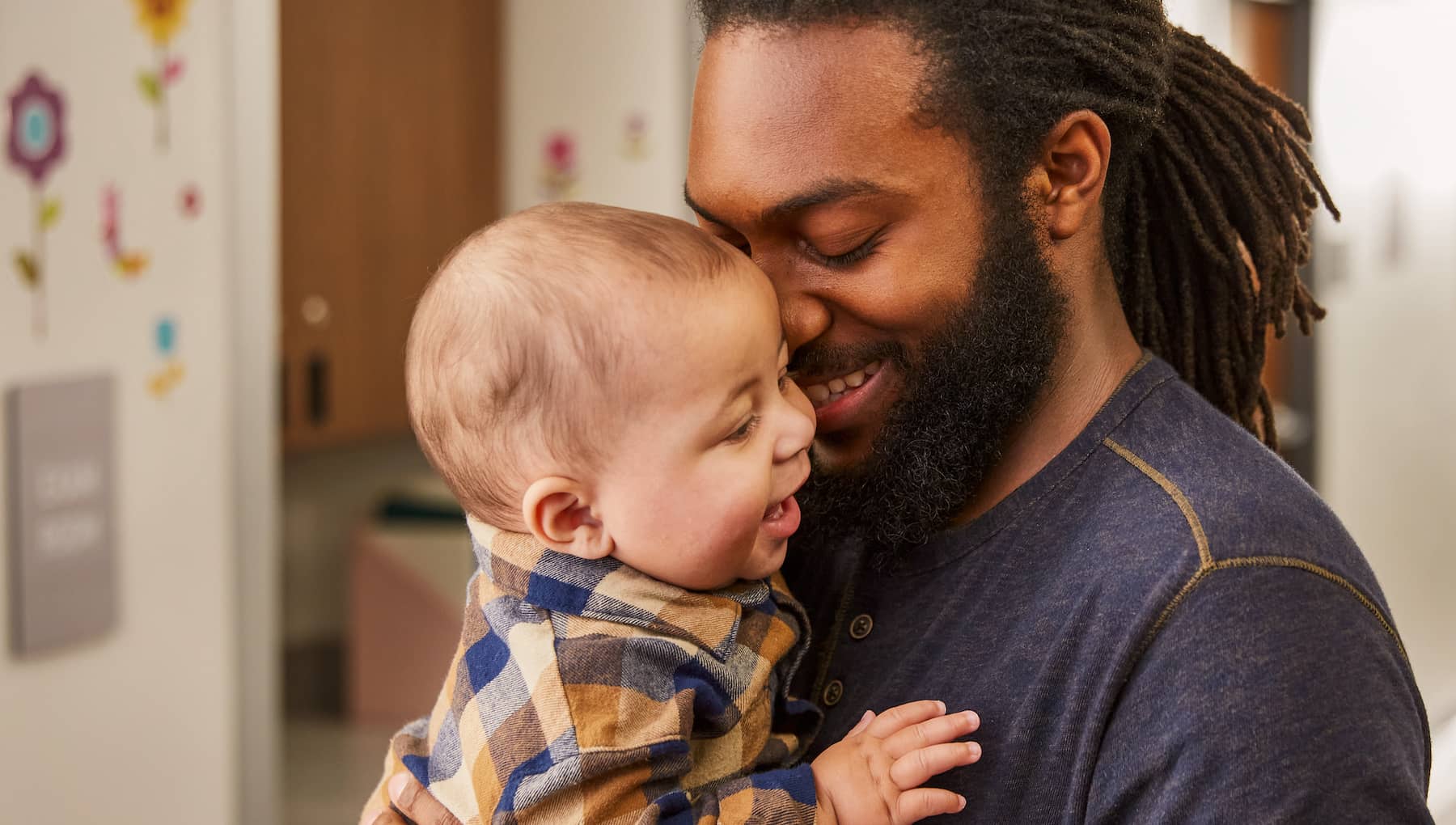 Dad snuggles a small baby