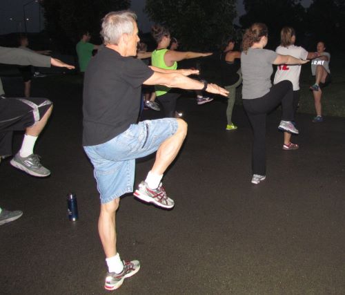An older white man follows a guided field exercise.