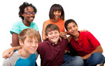 A group of diverse teenage students smiling at the camera. 